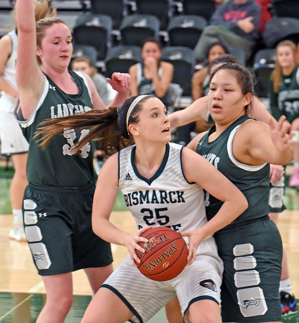 DCB's Lauren Gangl and Trinity Goggles playing defense Monday night.  Photo courtesy of the Bismarck Tribune.