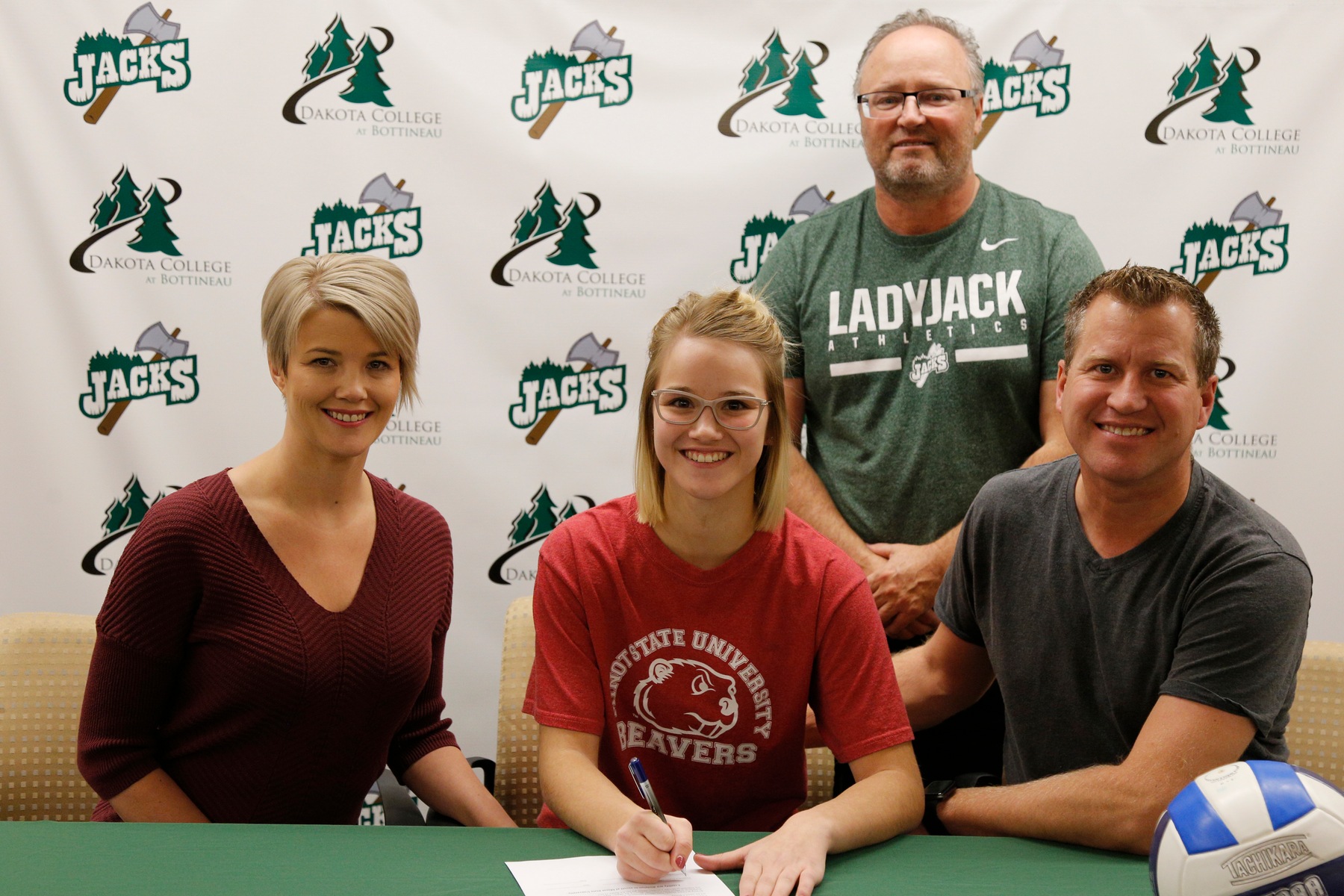 Sophomore Quinn Billaney, flanked by her mother Jaime and her father Cory, as well as DCB Volleyball coach Mike Smith, signs to play next season for NCAA Div. II Minot State University.
