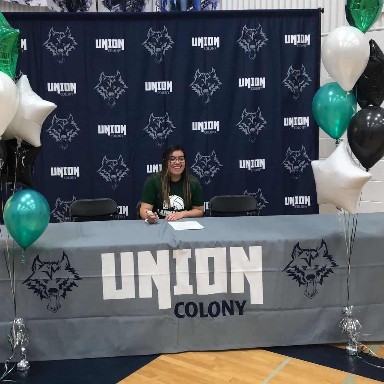 Jisela Chairez dons the Green and White of DCB as she signs her NJCAA Letter of Intent at her school Union Colony Prep in Greeley, Colorado.